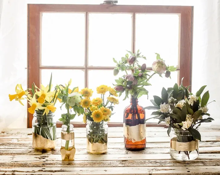 Ways to Upcycle Glass Jars & Bottles: DIY Gold Leaf Bottle Vases from Pretty Handy Girl.
