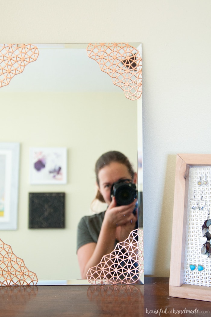 Add beautiful metal accents to a plain mirror. This DIY copper mirror is the perfect accent mirror for any room. Housefulofhandmade.com | DIY Home Decor | DIY Mirror Ideas | Copper Home Accents | Spellbinders