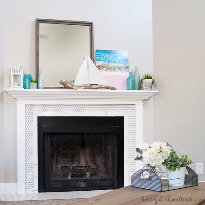 Create the perfect summer mantel decor with "found" beach objects. A DIY driftwood sailboat and mirror are the jumping off point for this soft beach house inspired summer mantel for the Decorate Your Mantel Series. Housefulofhandmade.com | Summer Mantel Inspiration | Beach Mantel Ideas | Sea Glass Decor | Sailboat Decor | DIY Summer Mantel 
