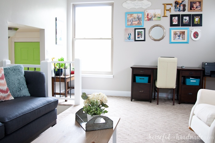 Livingroom with couch and desk.  Walls are painted agreeable grey by sherwin williams