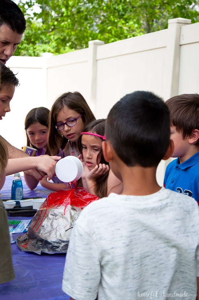 children around a volcano experiment at science themed birthday party