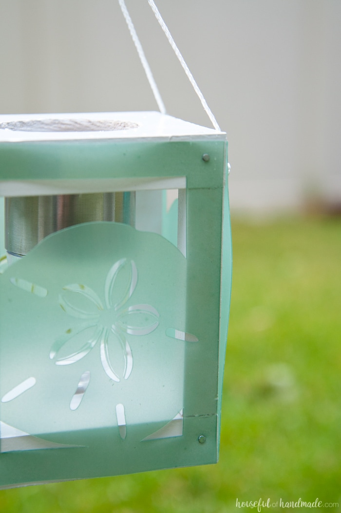 Create beautiful beach themed decor for the backyard with scrap wood, cheap solar path lights and your Silhouette Cameo. These coastal solar lantern decor will give beautiful lighting to the warm summer evenings. A fun and easy DIY for summer decorating. Housefulofhandmade.com | Silhouette Creators Challenge | Silhouette Crafts | Outdoor Crafts | DIY Solar Lanterns | Decorative Solar Lights 