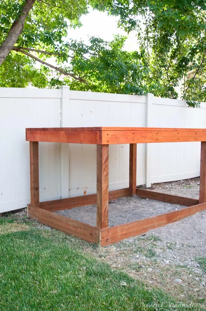 Even though our yard is small, we decided we still needed a DIY playhouse. Check out how we built the small playhouse for our kids, on a budget, starting with the deck. This project was so easy and now we can see the playhouse starting to take shape. Housefulofhandmade.com | How to Build a Playhouse | DIY Swing Set | Small Playhouse | Playhouse Build Plans 