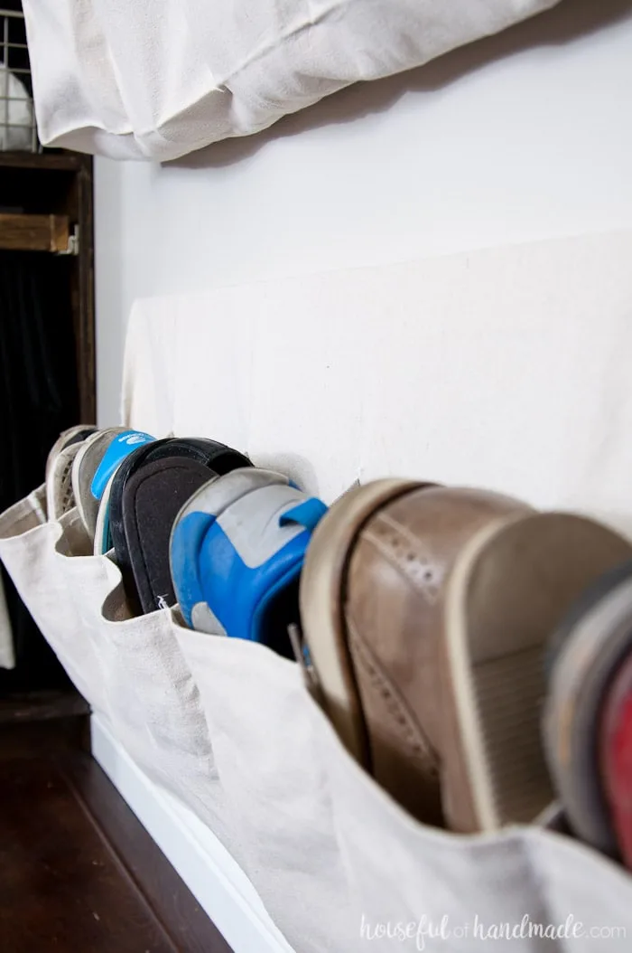 Sew shoe storage pockets out of drop cloth to keep all those shoes off the floor. See how we transformed our walk in closet into a dressing area on a budget. Housefulofhandmade.com