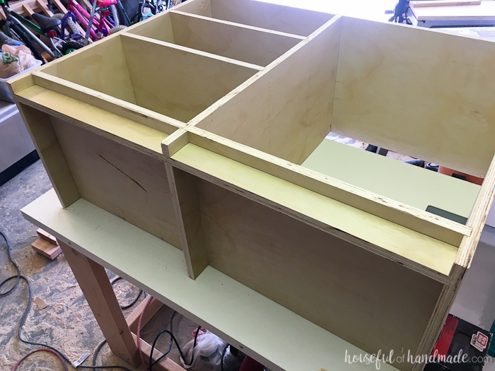 The bottom of the closet cabinet showing the toe kick installed in the grooves. 