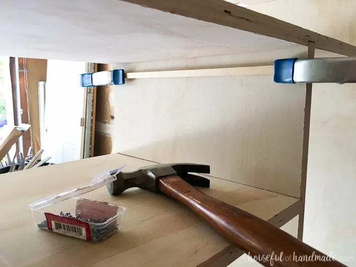 Showing the square dowel clamped and nailed inside the closet cubby. 