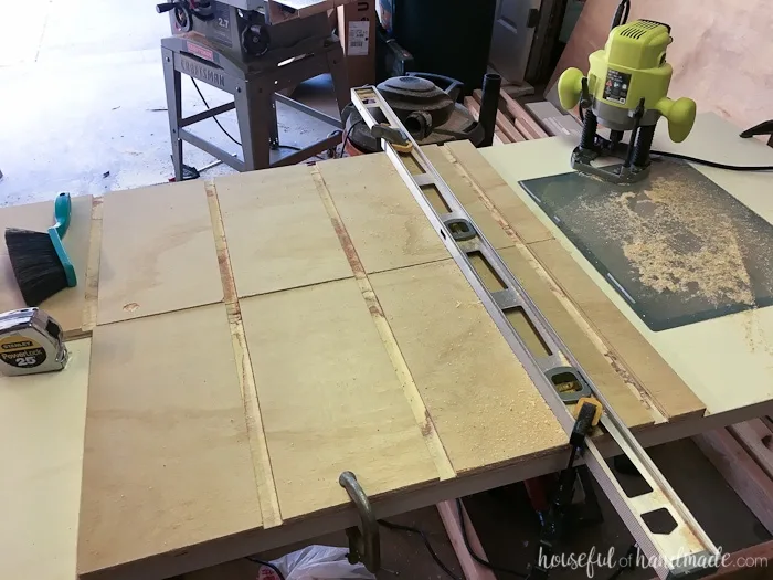 Cabinet showing all the grooves routed into the sides for the shelves to attach into by using a level clamped to the boards. 