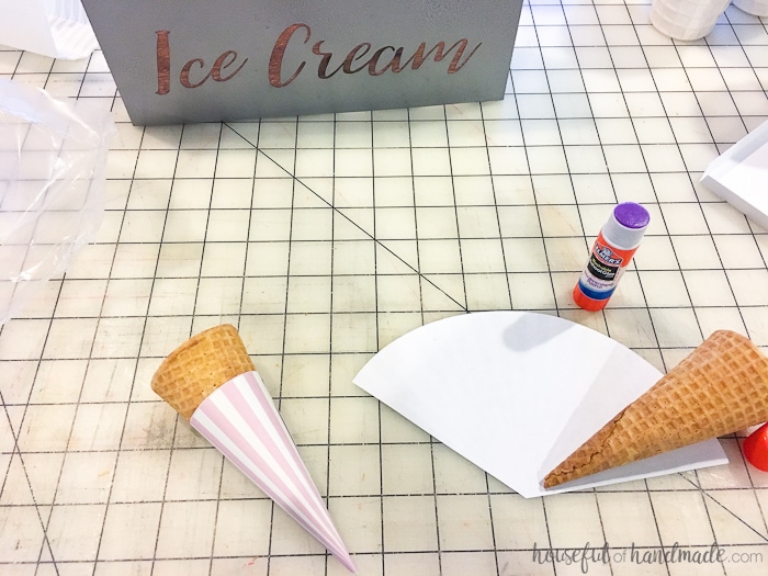 sugar cones being wrapped in paper with DIY farmhouse ice cream cone holder in the top of the image