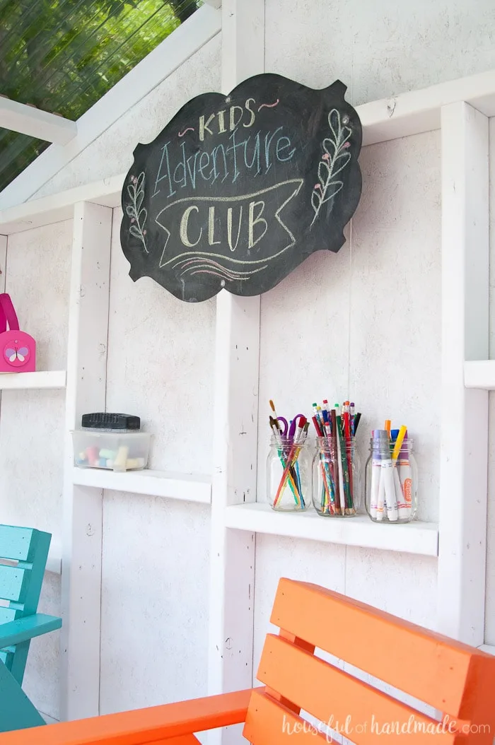 Using the open framework, shelves were built into the walls to hold all the kids treasures. Learn how to build an outdoor playhouse for the backyard at Housefulofhandmade.com