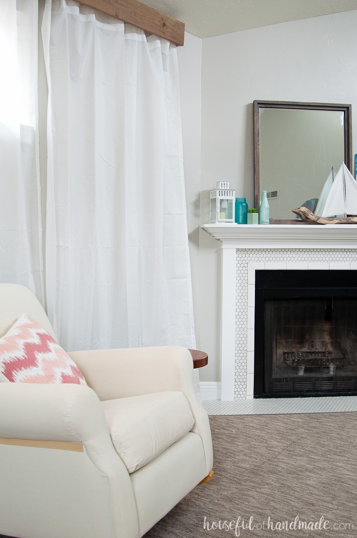 Neutral living room with DIY wood cornice box above the sheer white curtains on the wall.