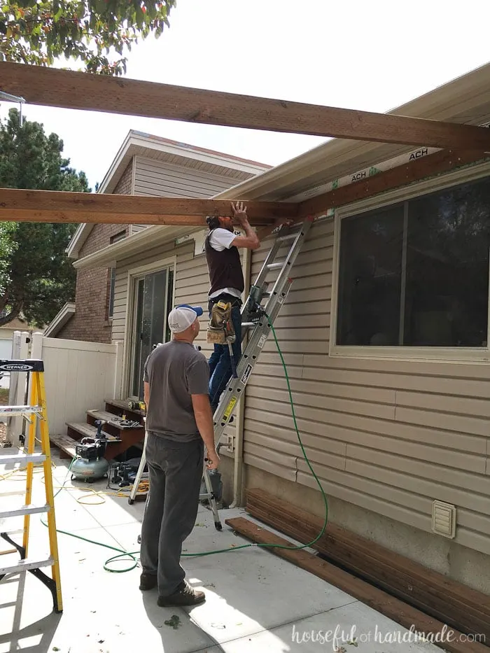 Building a pergola attached to the house. How to attach cross beams to the header. Housefulofhandmade.com