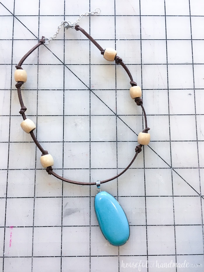 This easy DIY Moana necklace with brown cord and ivory beads with large turquoise bead.