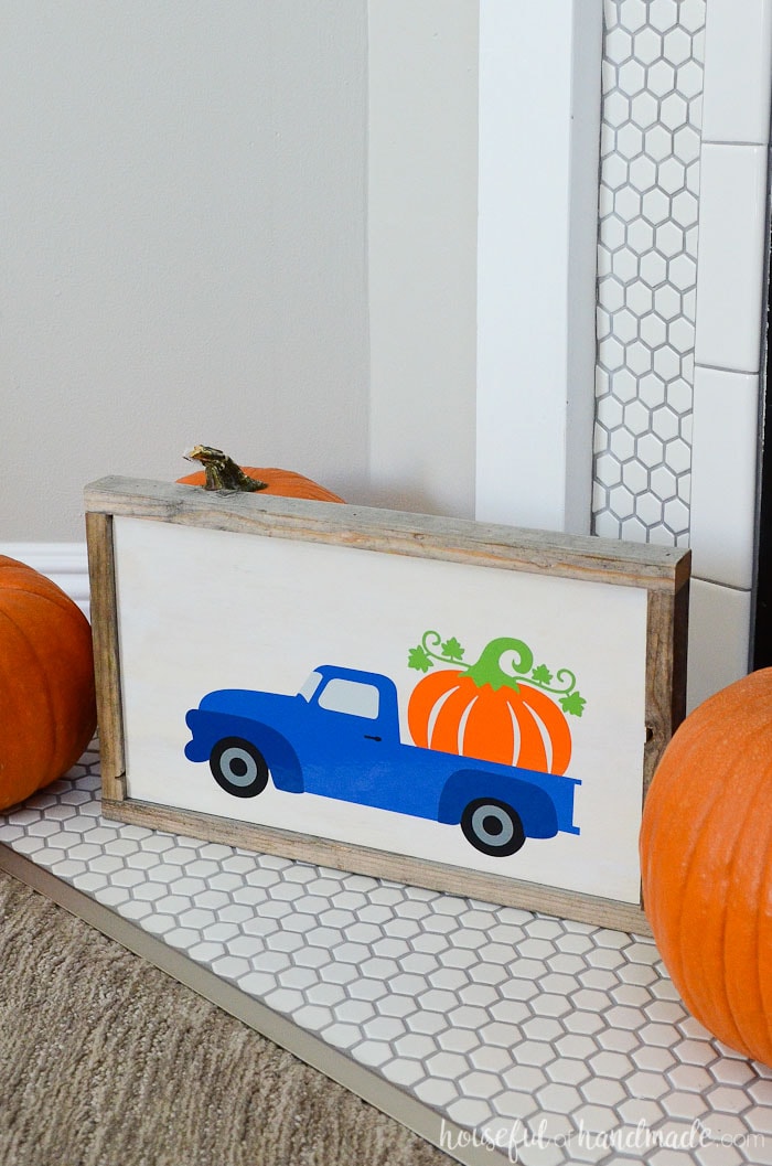 Make an easy wood pumpkin sign from reclaimed wood to celebrate fall. The adorable truck hauling a large pumpkin is perfect for fall decorating. Housefulofhandmade.com