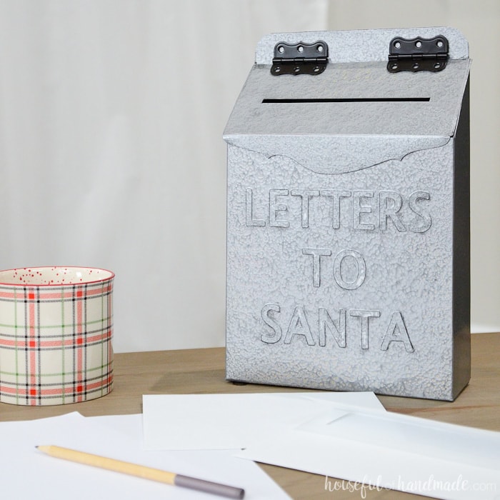 Paper Christmas decor idea: A Letters to Santa mailbox made from an upcycled cereal box on a table. 