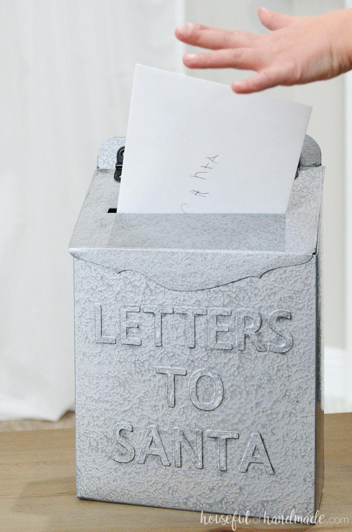 Santa mailbox with card being placed inside and small hand