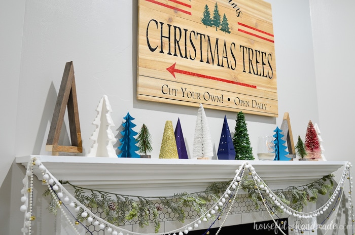 I love this beautiful holiday mantel decor. A forest of DIY Christmas trees is the perfect budget Christmas decor. Housefulofhandmade.com