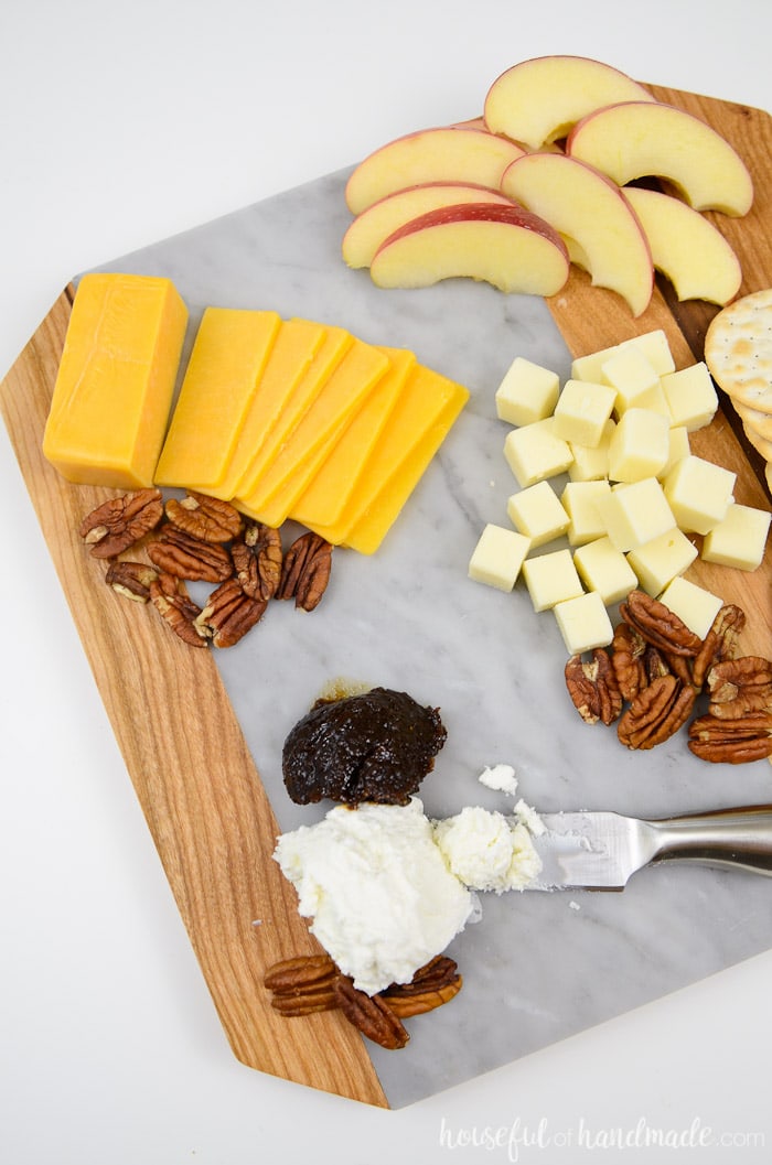 A marble cheese board is the perfect accessory for the holidays. This wood and marble cutting board is perfect for displaying your favorite cheese plate, appetizers, or as a DIY hostess gift. Housefulofhandmade.com