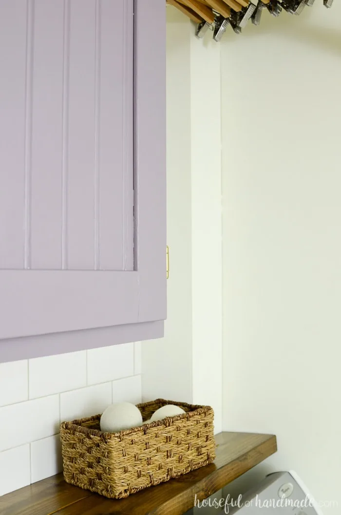 Farmhouse laundry room with purple cabinets and barnwood shelf. Housefulofhandmade.com