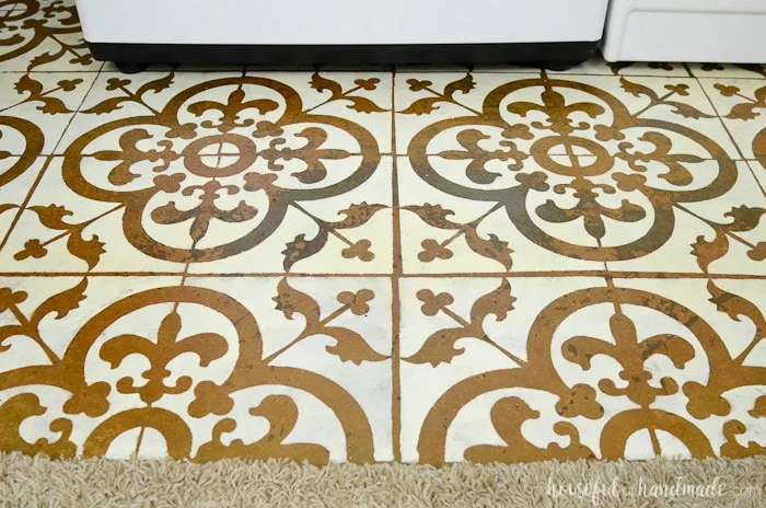 Cement floor with stenciled tile pattern on it in the farmhouse laundry room. Housefulofhandmade.com