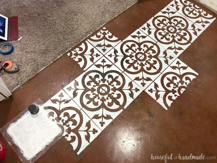 I love this floor stencil! It looks like painted concrete tiles. See the complete transformation at Housefulofhandmade.com.