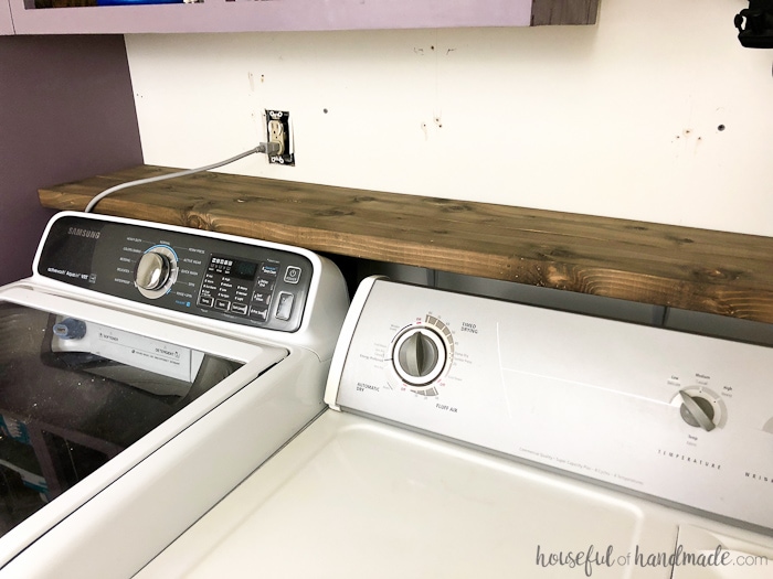 This beautiful barnwood shelf is perfect for our modern farmhouse laundry room remodel. See how to fake aged barnwood with this budget solution. Housefulofhandmade.com