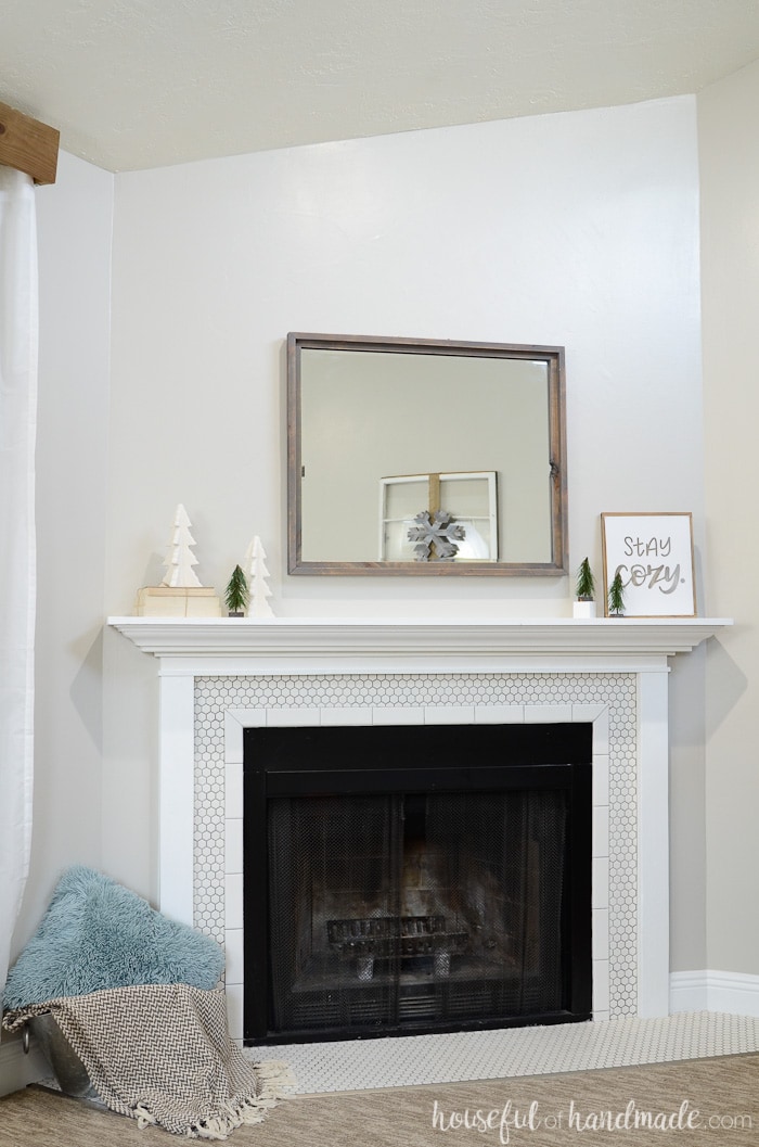 Neutral Christmas trees transition the mantel from festive to winter. Housefulofhandmade.com