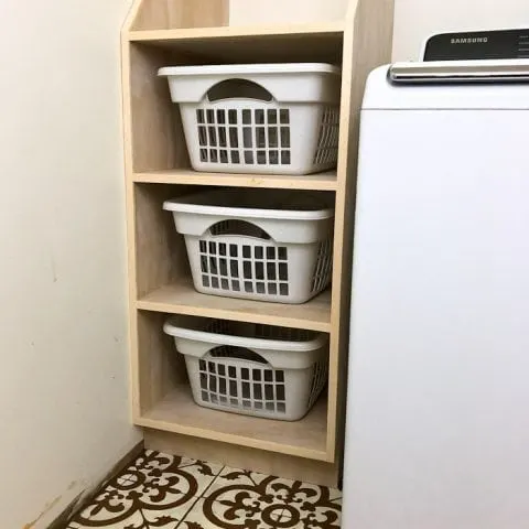 Organize your laundry room with this stackable laundry basket storage. This easy to build shelf unit is the perfect laundry basket organizer so you can keep your dirty laundry hidden. Get the build plans from Housefulofhandmade.com.