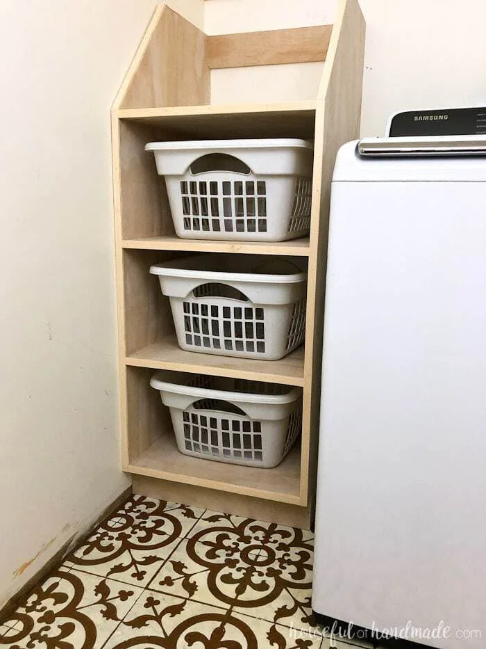 Use these amazing DIYs to Organize your home this year. Organize your laundry room with this stackable laundry basket storage. This easy to build shelf unit is the perfect laundry basket organizer so you can keep your dirty laundry hidden. Get the build plans from Housefulofhandmade.com.