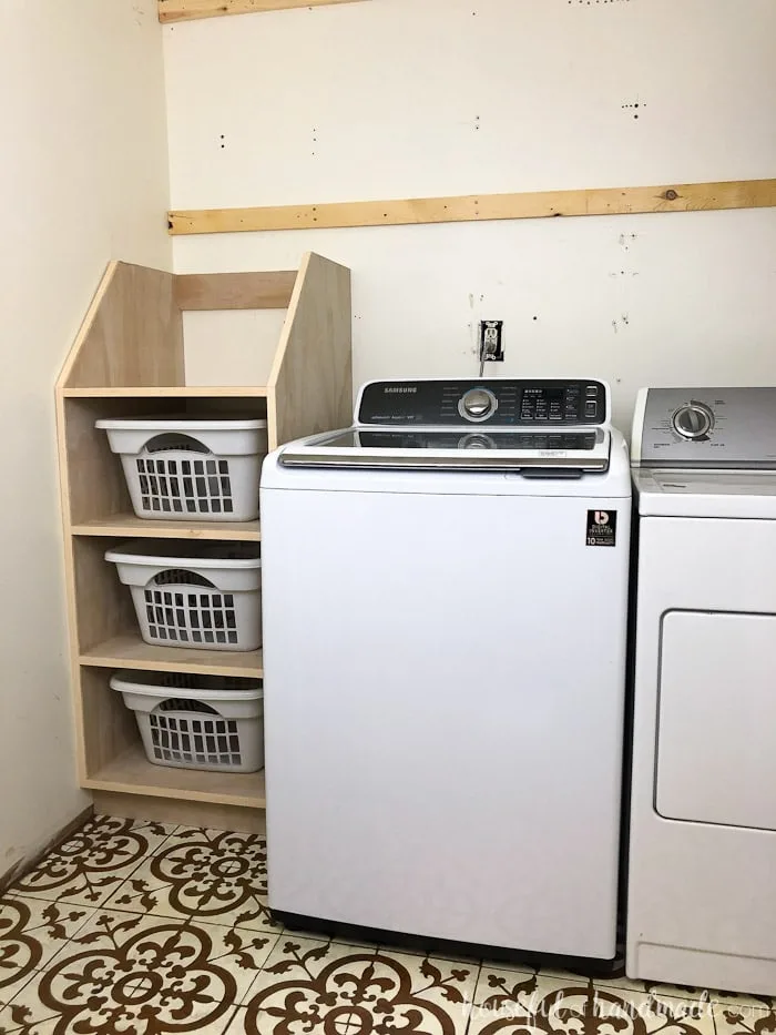 Stackable laundry basket storage shown in laundry room. 