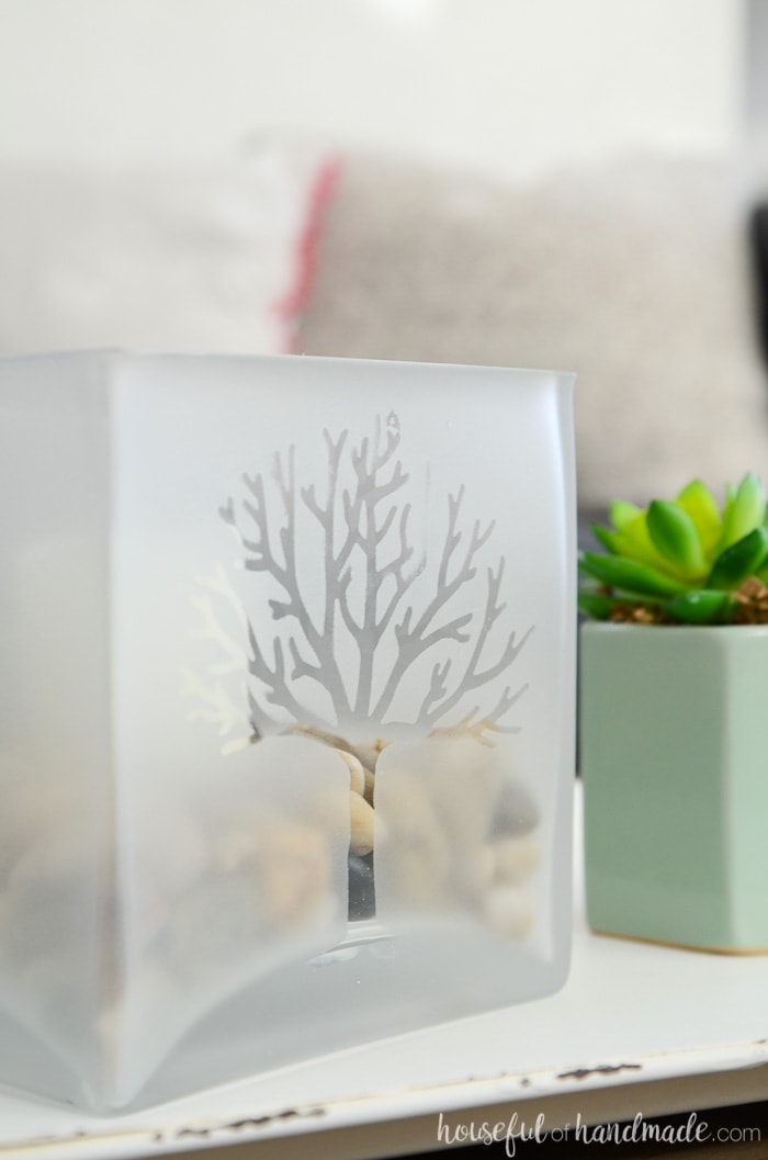 A tree design in a frosted glass candle holder. On a tray next to a succulent. Housefulofhandmade.com