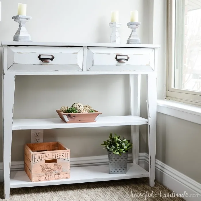 Build a beautiful small console table to add storage and decor to your home. This DIY farmhouse console table has two large drawers and two shelves. Housefulofhandmade.com