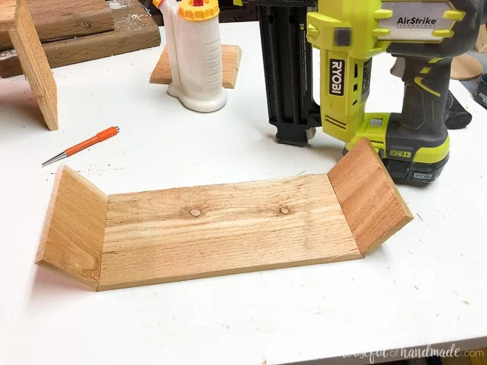 Attaching the side boards to the bottom of the countertop herb garden. Housefulofhandmade.com