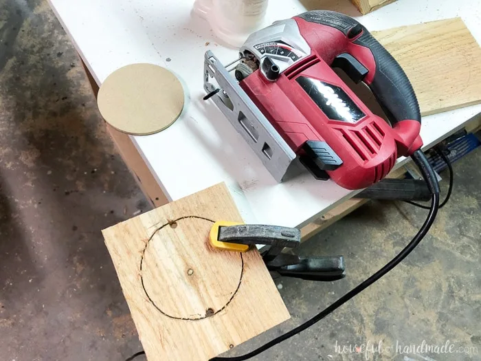 Cut out a hole for the terra cotta pots to make the indoor herb garden planters. Housefulofhandmade.com