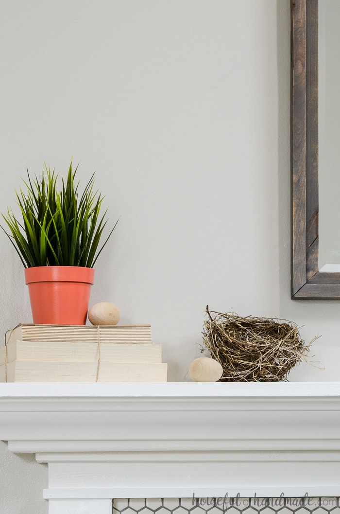 Use found items like nests in your mantel decor for spring. See all the spring decorating tips at Housefulofhandmade.com.