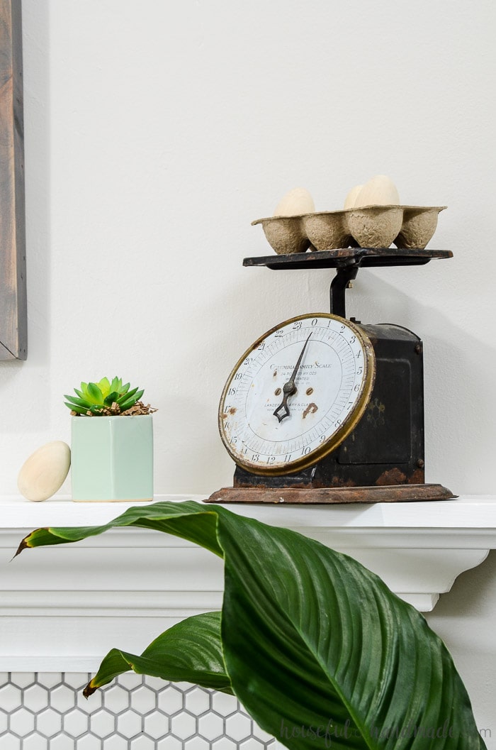 Turn a vintage scale into spring decor with inexpensive wooden eggs. The perfect mantel decor for spring. Housefulofhandmade.com