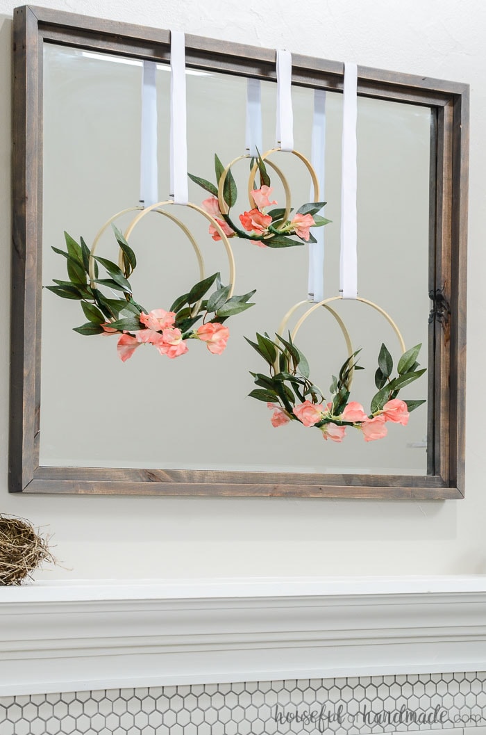 Coral flowers on an embroidery hoop wreath. Hung as part of our simple mantel decor for spring. Housefulofhandmade.com