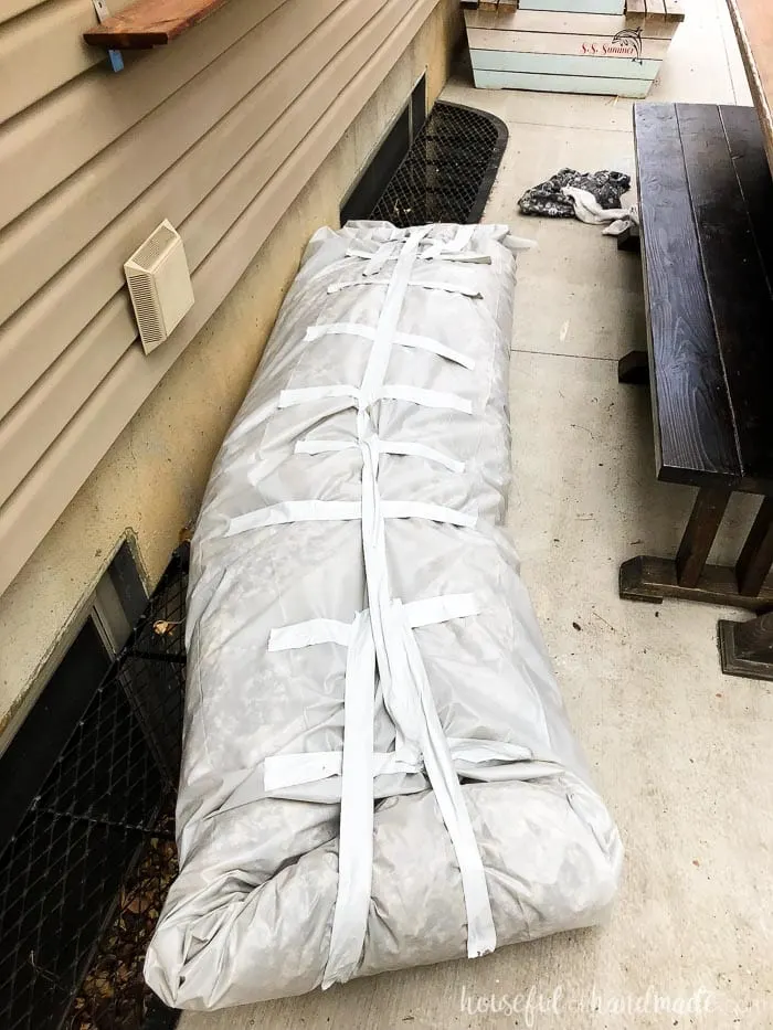 Packing up the insulation falling from the attic during our DIY kitchen remodel to save some money. Taped all the insulation up inside plastic tarp to carry it back into the attic. Housefulofhandmade.com