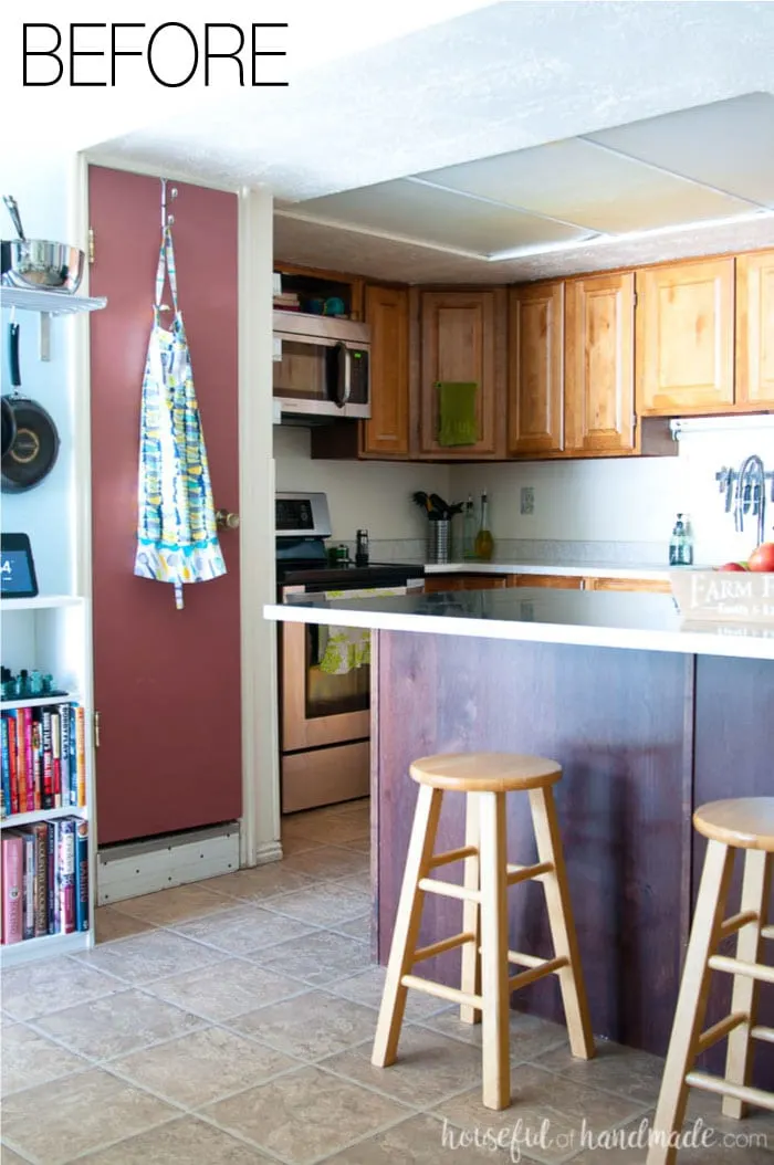 Say goodbye to narrow pantry closets and a drop ceiling in this budget farmhouse kitchen remodel. See the after at Housefulofhandmade.com.