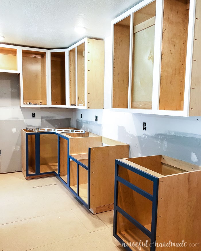 Installed cabinet boxes without doors in teh kitchen remodel. The DIY kitchen cabinets were installed on 2x4 base.