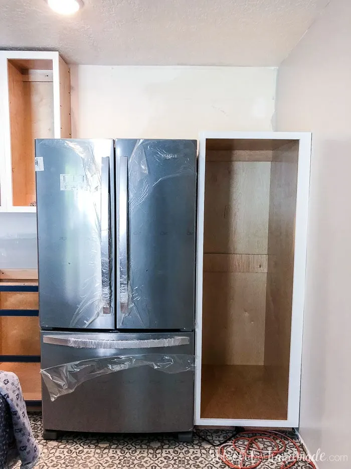 The new stainless steal fridge is in place next to the DIY pantry cabinet. Housefulofhandmade.com