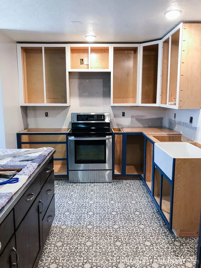 All the cabinet boxes are installed. I love the two-tone kitchen. See our tips for surviving a kitchen remodel at Housefulofhandmade.com.