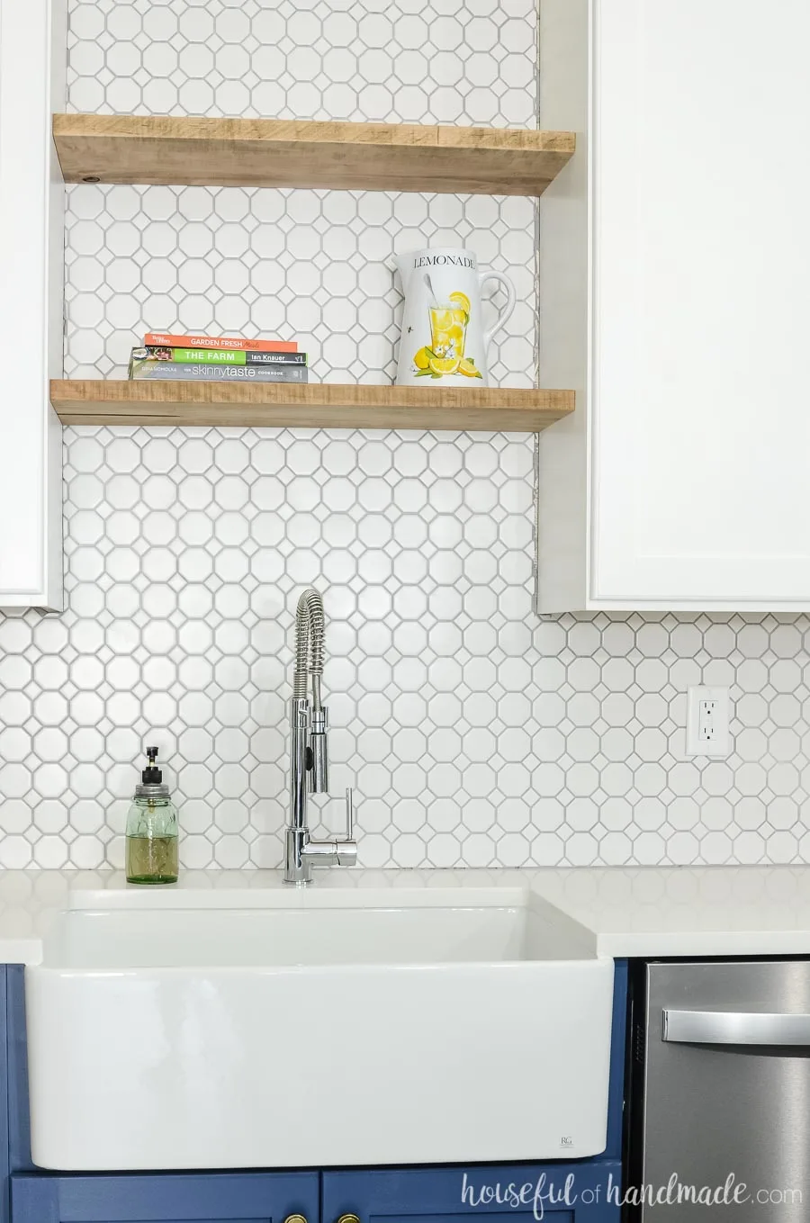 Thick maple boards were turned into floating shelves above the kitchen sink. White octagon tile is the perfect backsplash to fill the space behind it. Housefulofhandmade.com