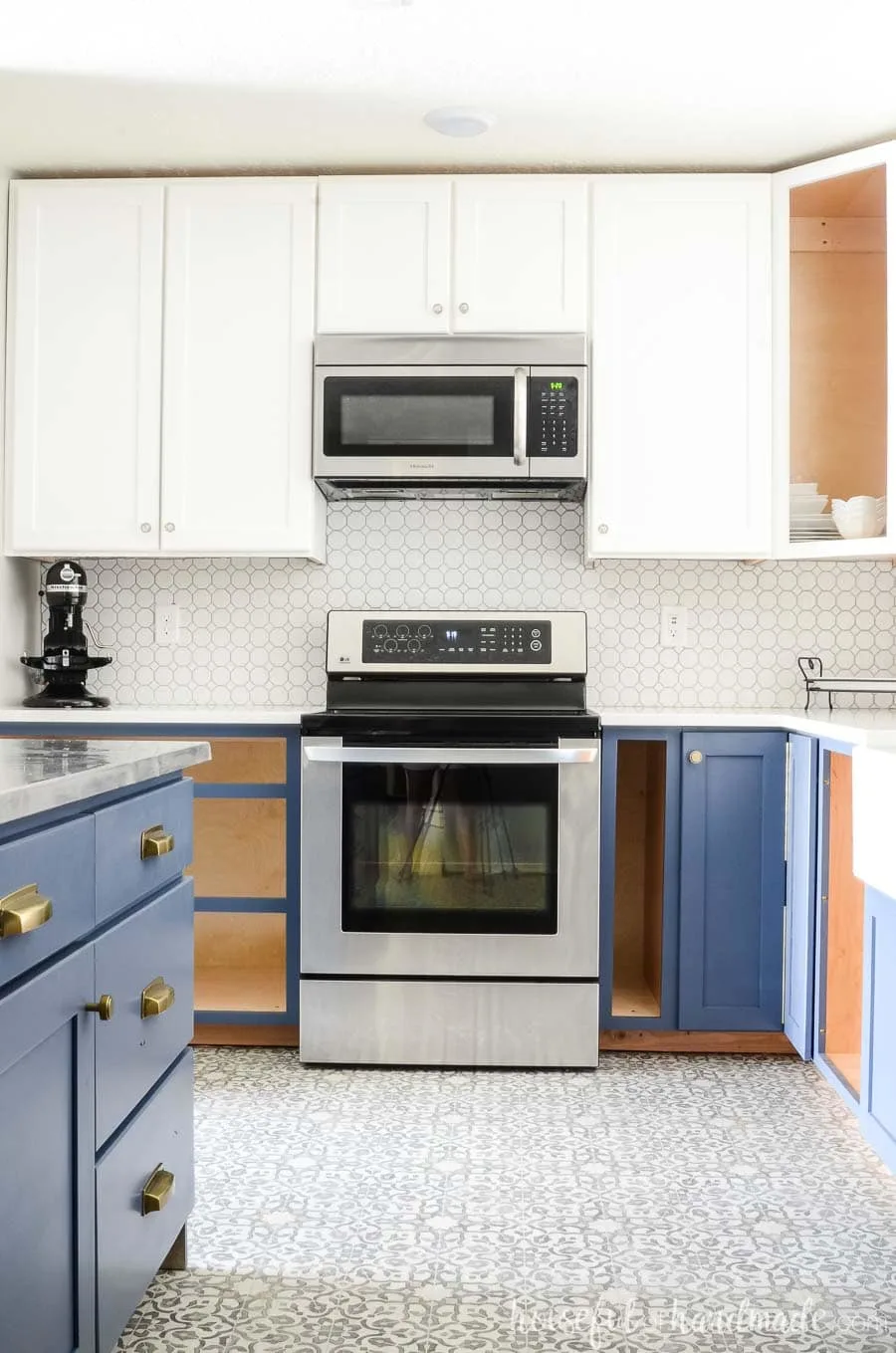 A complete kitchen remodel on a budget is possible. We turned our outdated kitchen into a bright farmhouse space with white wall cabinets and navy base cabinets. Housefulofhandmade.com