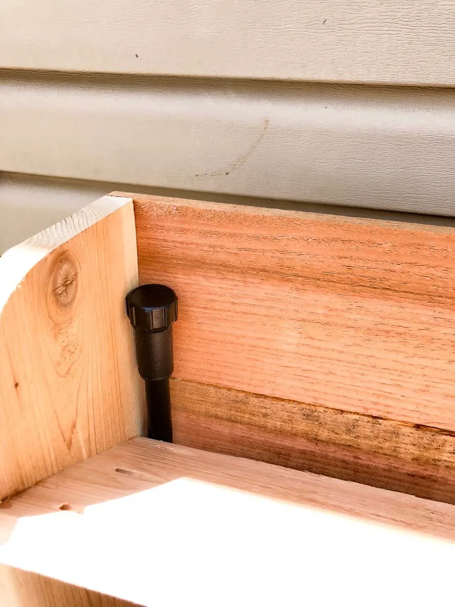 Cap off the top of the tubing for the drip watering system in the vertical herb garden. Housefulofhandmade.com