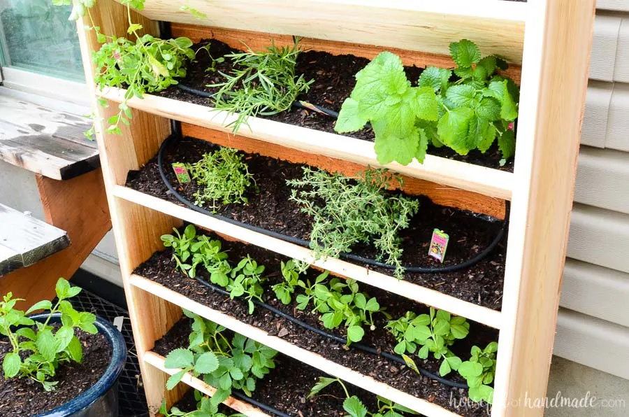 This vertical cedar garden was built in just an hour and makes the perfect small space garden idea. Includes a drip watering system to keep your plants healthy all season. Get the tutorial at Housefulofhandmade.com.