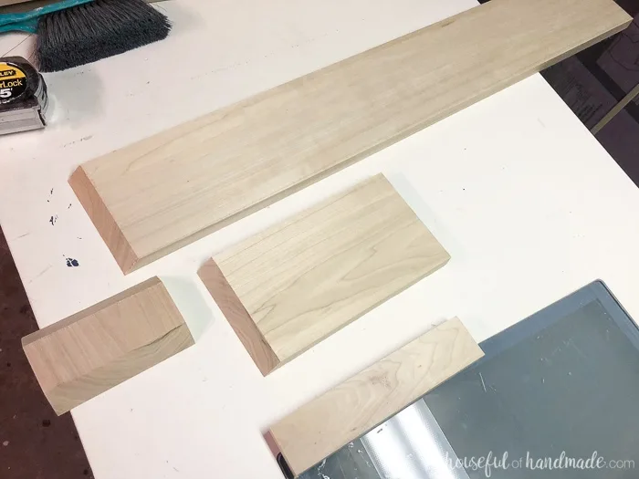 Pieces of hardwood to build the decorative base for the kitchen island makeover.