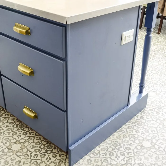 Kitchen island shown painted blue with gold hardware. 