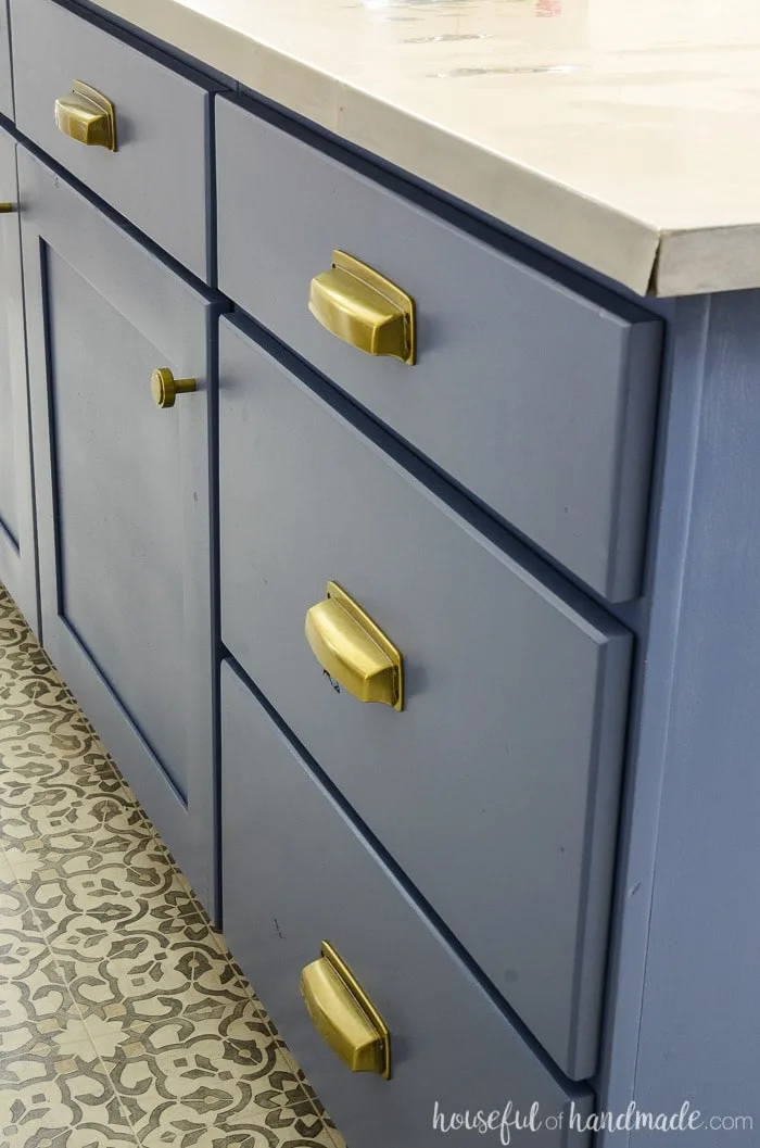 Close up of Brass cup pulls on this navy kitchen island makeover. 