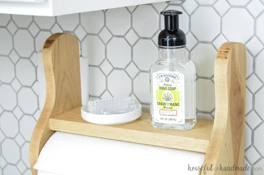 Close up of farmhouse paper towel holder with shelf