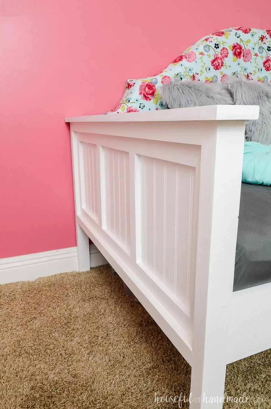 Beadboard details make the sides of this upholstered day bed so chic. Bright white frame with a bold floral upholstered headboard make this day bed the perfect focal point of the room. Free build plans at Housefulofhandmade.com.